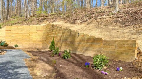 Large retaining wall in wooded area