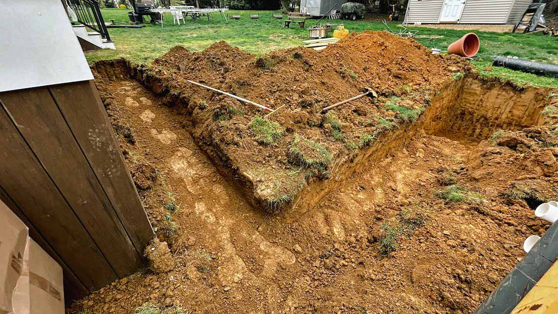 We begin the French drain system with precise excavation to redirect rainwater, preventing erosion and oversaturation in the yard. Expert Excavation and Site Preparation