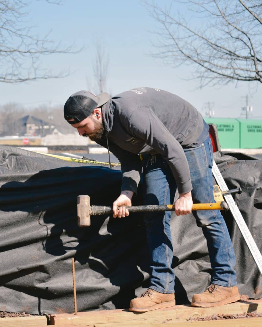 Team Member onsite with sledge hammer