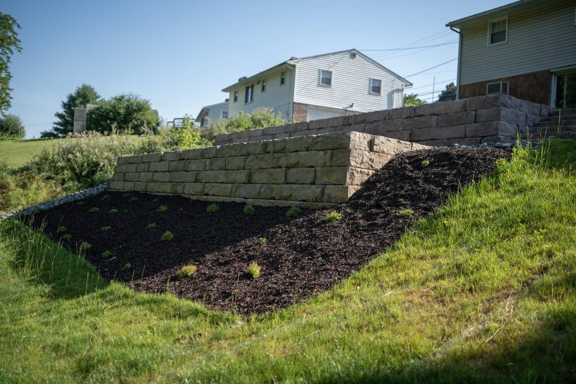 Retaining Wall Comparison: Grand Ledge vs. Timber — Which Is Right for Your Property?
