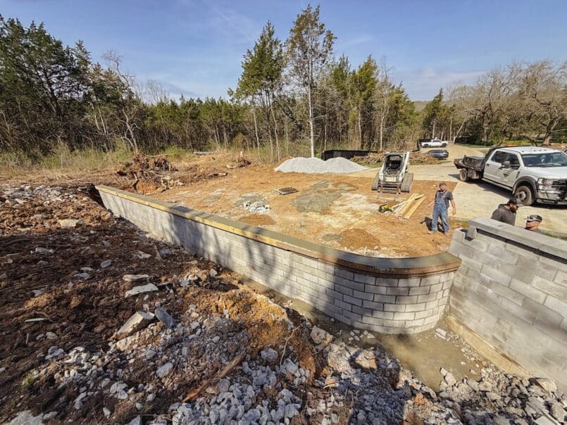 With the concrete wall